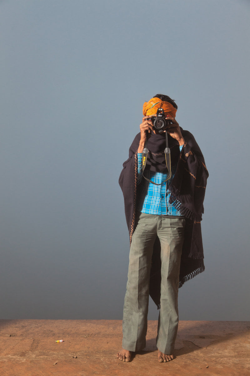 A pilgrim taking a photo at Keshi Ghat #7/8